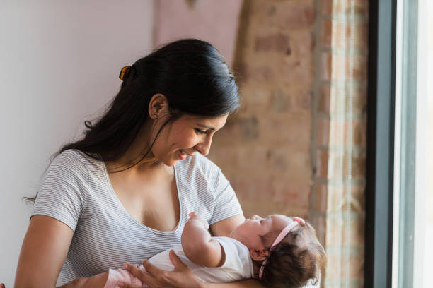 istock Mother and Baby Bonding Near Window, Soft Light 2198015183