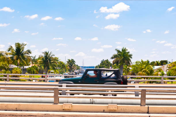 Car drives over a intercoastal waterway bridge in Cape Coral, Florida, USA.