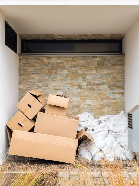 istock Discarded cardboard boxes and white trash bags are ready for recycling outside a building 2198018903