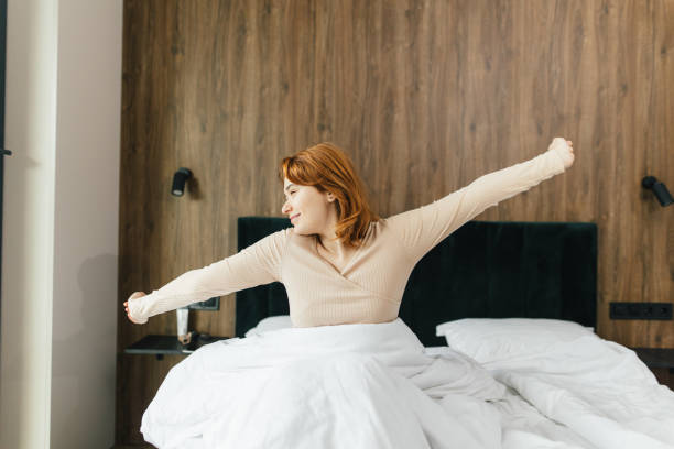 istock Refreshing Morning: Energized Woman Waking Up with Joy 2198022273