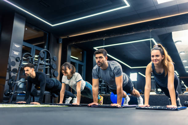istock Group of sporty people doing plank exercise. 2198025310