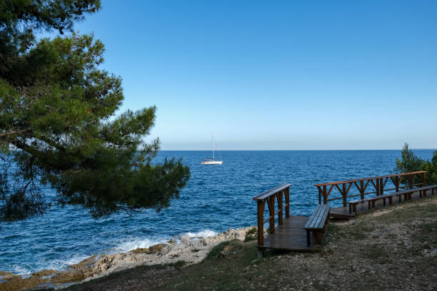 istock Coastal Viewpoint with a Sailboat on the Horizon 2198025693