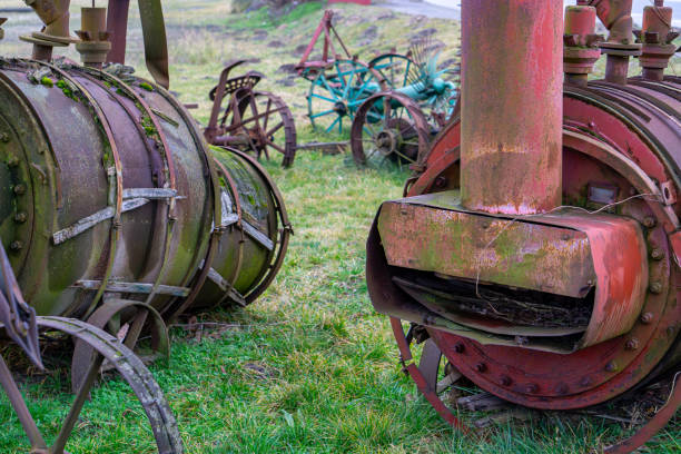 agricultural machinery scrapyard. old metal rusty boilers.