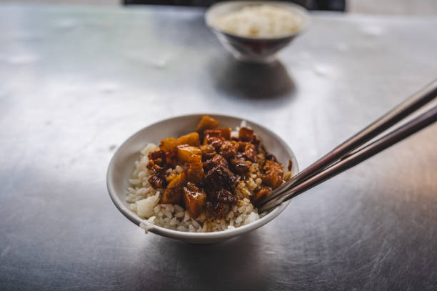 close up Lu Rou Fan also known as Taiwanese Braised Pork Rice on the table with iron chopstick