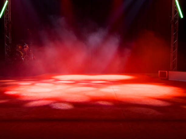 istock Empty stage with red lights and smoke effects in theater setting 2198030313