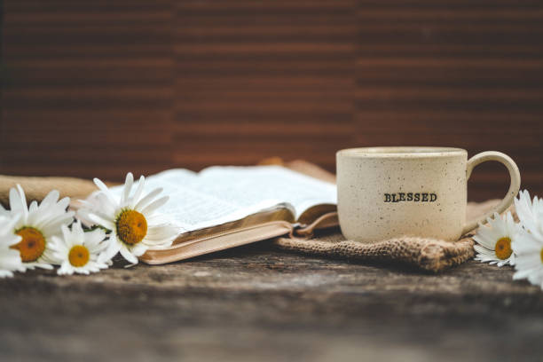 istock Cup with the inscription blessed and open Bible, Christian concept 2198030331