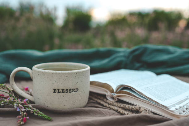 istock Cup with text BLESSED and open Bible in the garden, good morning 2198030336