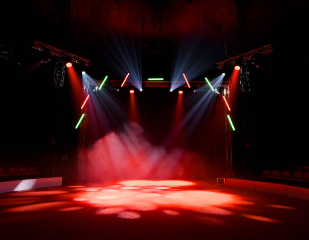 istock Colorful stage lights illuminating empty circus arena with smoke effects 2198030497