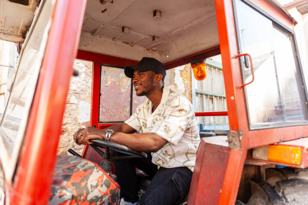 Portrait of afro men driving tractor