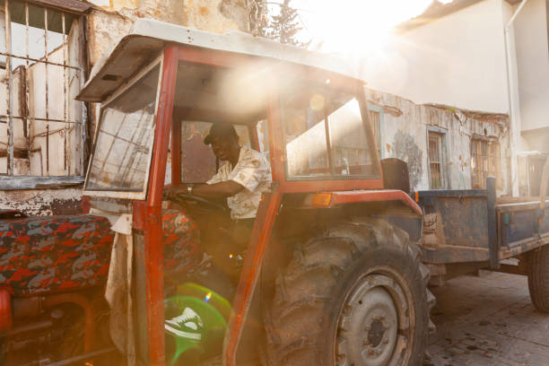 Portrait of afro men driving tractor
