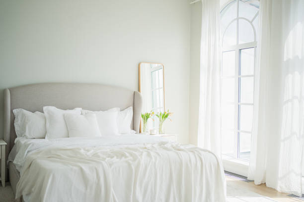 Modern bedroom in white tones with white furniture.