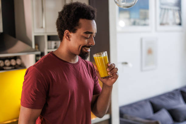 istock Man enjoying a refreshing juice at home 2198033369