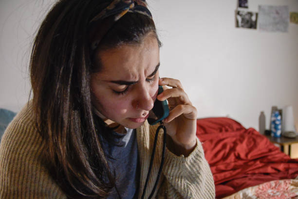 istock Woman speaking on the phone with a concerned expression, close-up 2198034388