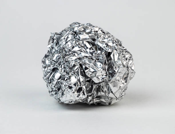 istock Crumpled aluminum foil resting on a white background 2198035060