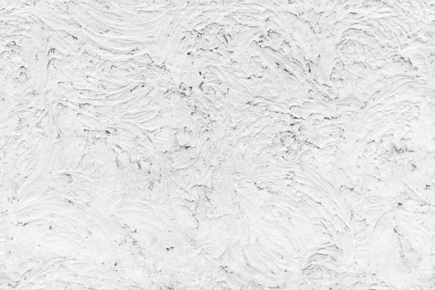 Grungy white concrete wall with stucco relief texture, seamless background photo