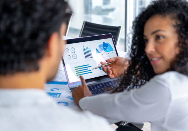 istock A couple looking at and discussing  financial data with graphs and charts. 2198045221