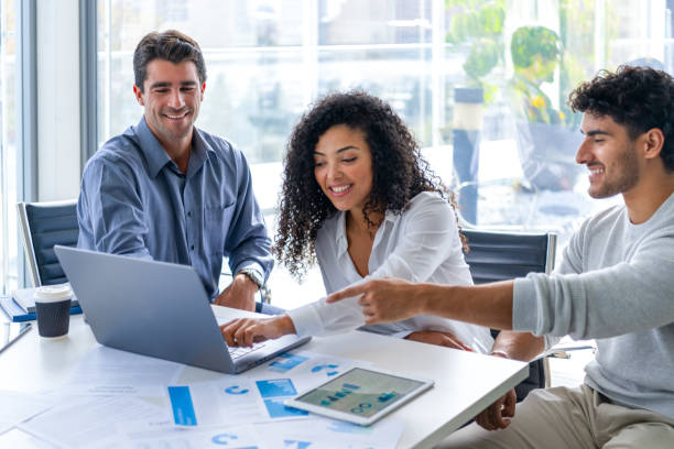 istock Three people looking at and discussing  financial data with graphs and charts. 2198045286