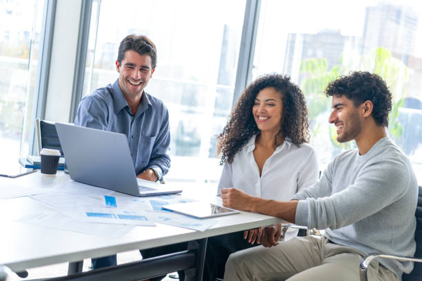 istock Three business people working in the office with technology.. 2198047113