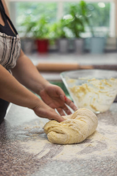 A woman kneading dough for fresh homemeade donuts