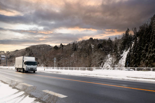 A semi truck traveling with cargo to deliver during the winter in Japan.