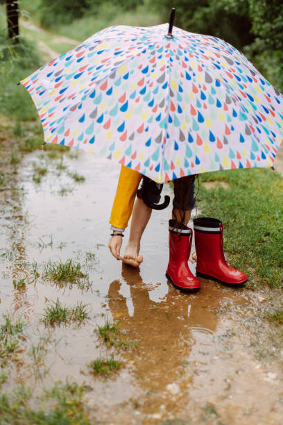 istock Barefoot Bliss: Jumping in Puddles on a Rainy Day 2198057806