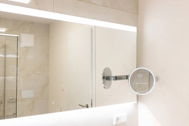 istock LED Bathroom Mirror. Magnifying mirror sets new standards in self-care. Mirror for precise makeup and thorough skin care. Self-care concept. Mirror with lighting is ideal for dark mornings 2198057871