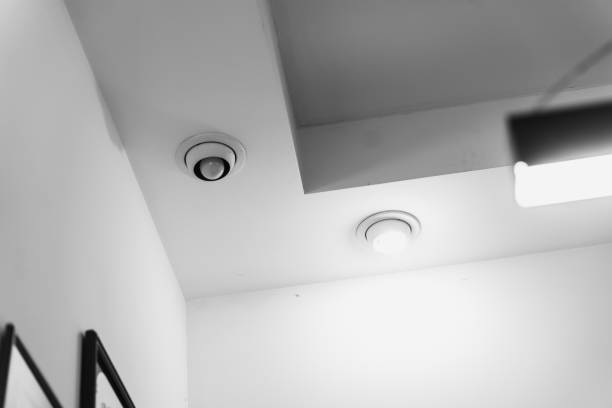 Travel concept. Low angle view of modern aeroport terminal lounge area and futuristic design of HVAC ceiling.