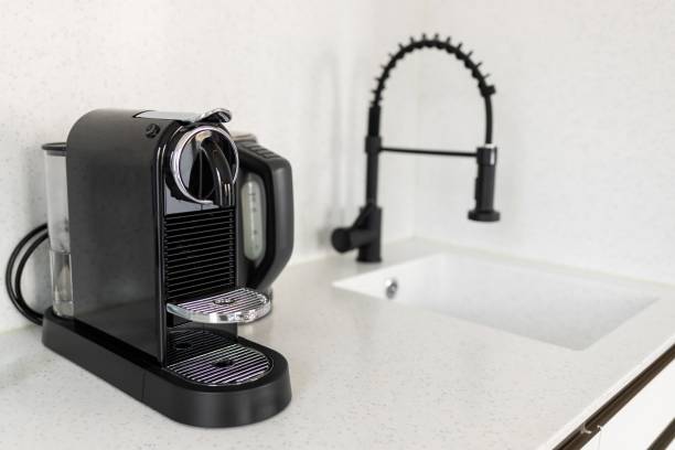 istock modern coffee machine for capsules on the kitchen worktop. Morning coffee is a boost of energy for the whole day. Coffee is the best drink for a sleepy morning 2198058454