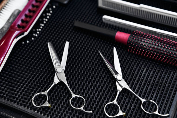 istock Quality hair scissors and styling tools arranged on a salon table 2198058459