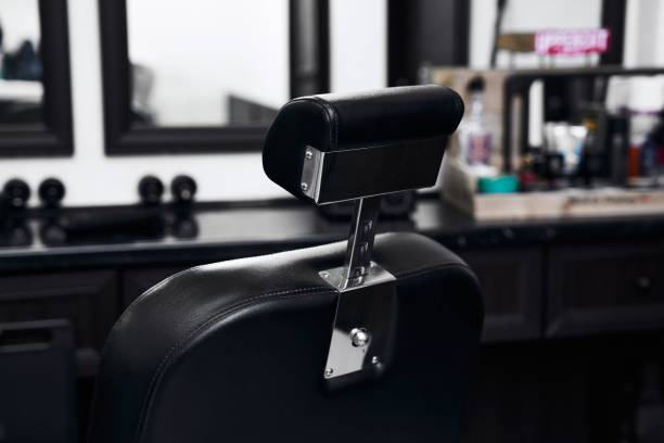 istock Black leather barber chair with sleek design in a modern salon interior 2198059985
