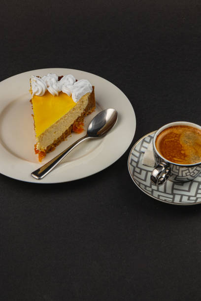 Delightful orange cheesecake served with fresh espresso coffee on a plate