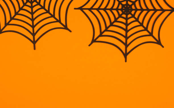 istock Decorative spider webs on a vibrant orange background for Halloween celebrations 2198065089