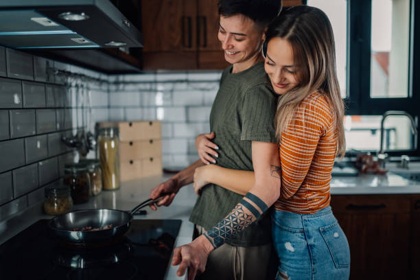 istock Lesbian couple cooking together in modern kitchen 2198065272