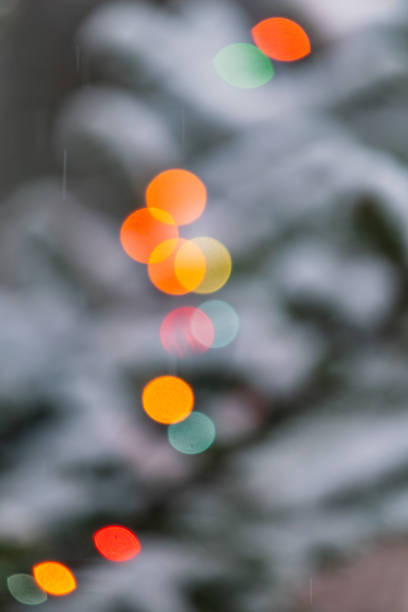 istock Bokeh lights twinkle on a snow covered Christmas tree in winter’s embrace 2198066850