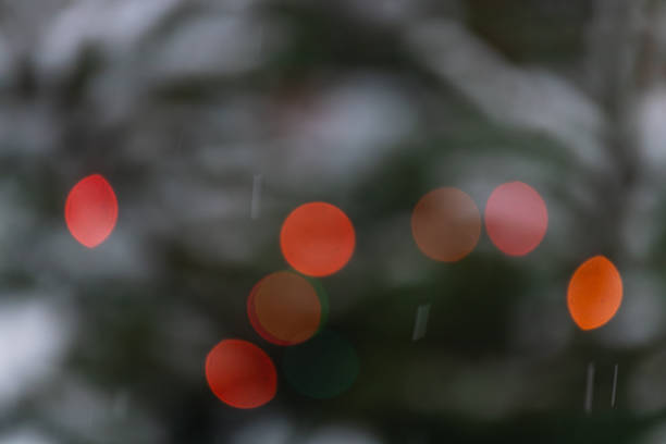 istock Captivating bokeh of festive lights shimmering on a snow dusted tree 2198067960