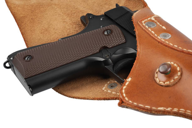 M1911 Automatic Pistol, Caliber .45 in holster M1911 Automatic Pistol, Caliber .45 in holster isolated on white background forty five caliber handgun stock pictures, royalty-free photos & images
