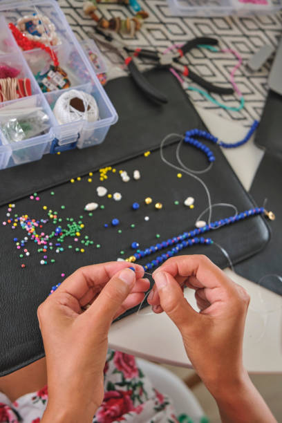 istock Close-up of hands making handmade jewelry 2198077367