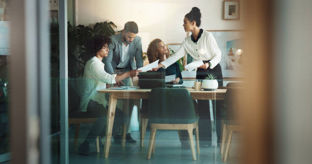 istock Coaching, collaboration and documents with business people in office together for project management. Meeting, seminar or workshop with team of men and women in workplace for planning or strategy 2198078503