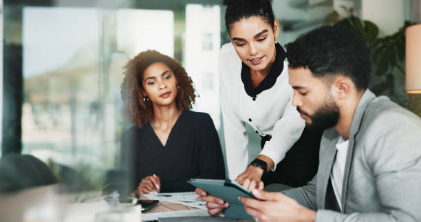 istock Pointing, project management and tablet with business people in office for graphic design discussion. Meeting, web development and question with employee team in workplace for planning or strategy 2198078567