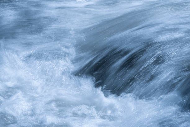 A long exposure image that blurs the motion of a flowing river.