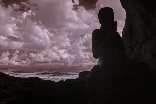 Infrared color, a cave with several Buddha statues positioned inside