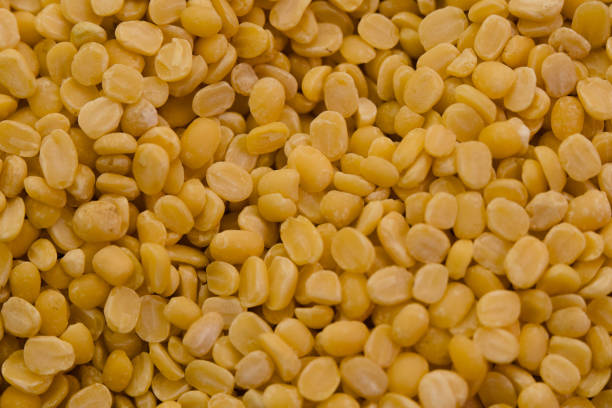 istock Neatly arranged yellow split peas highlighting their texture and color 2198089404