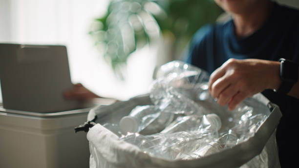 Woman separating waste plastic bottle.