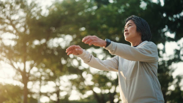 istock Senior woman relax exercise at park. 2198092853