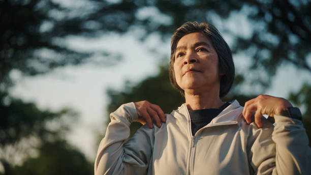 istock Senior woman relax exercise at park. 2198092879