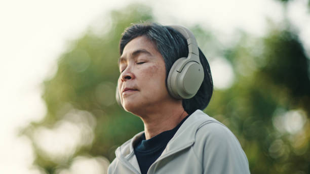 istock Senior woman meditating at park. 2198093119