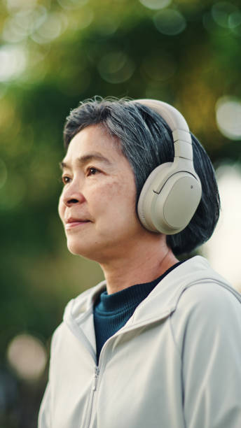 istock Senior woman meditating at park. 2198093706