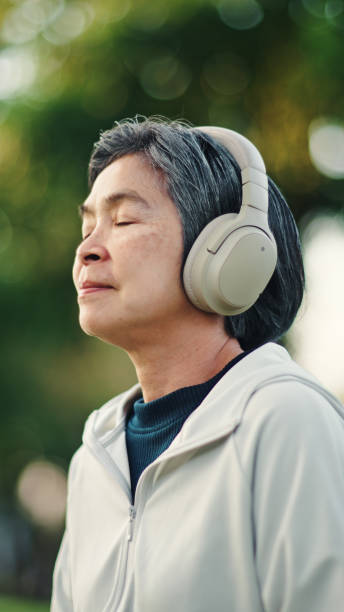 istock Senior woman meditating at park. 2198093707