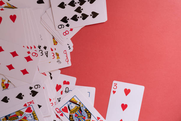 istock Shuffled playing cards on a red background 2198093749