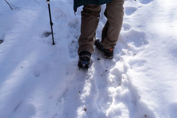 Crampons on feet climbing a snowy mountain